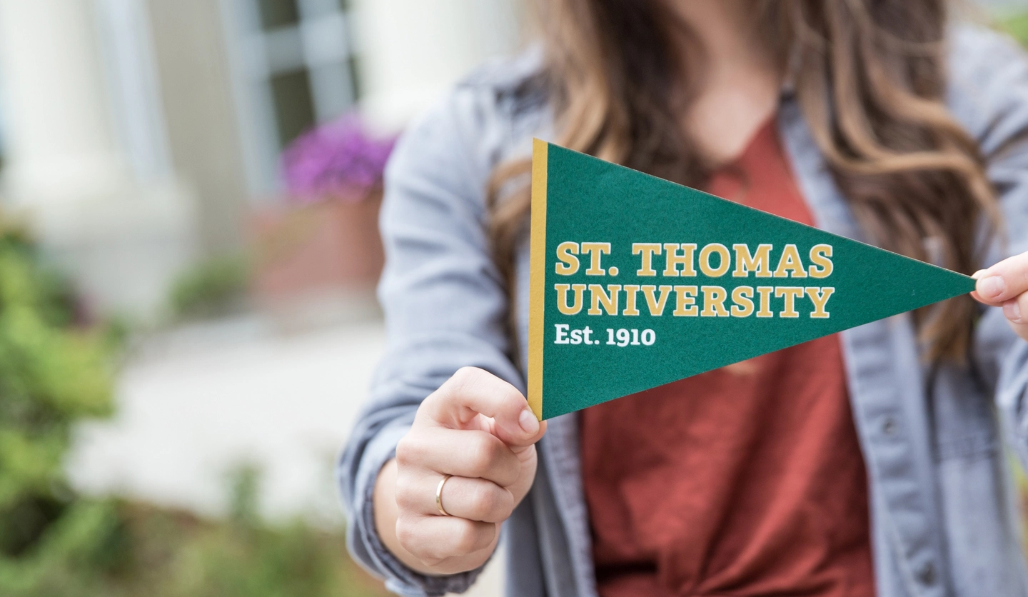 STUdent holding STU pennant