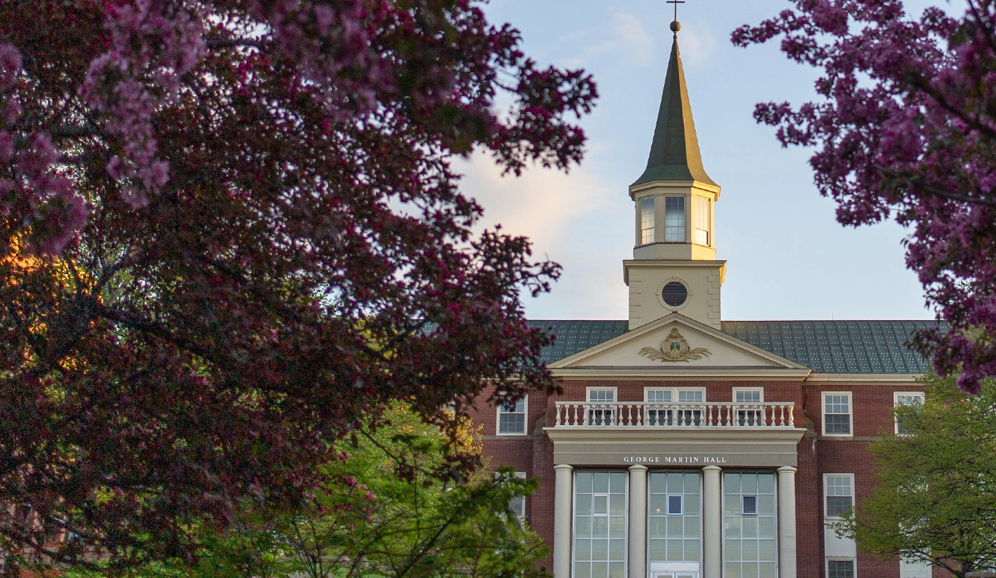 A photo of george martin hall with flowers surrounding it