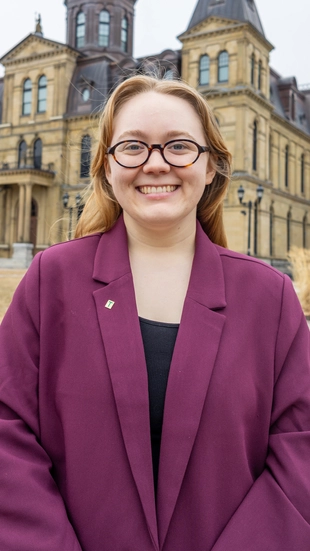 Grace Cunningham standing outside of the New Brunswick Legislative building.