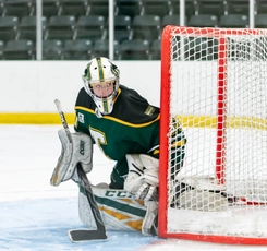 ���߲ݴ�ý Tommies goaltender Katie Sweeney stands at the edge of the crease, watching the play behind her net.