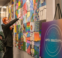 student looking at art wall