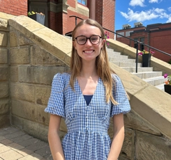 Emily Nylen standing in front of Fredericton City Hall building