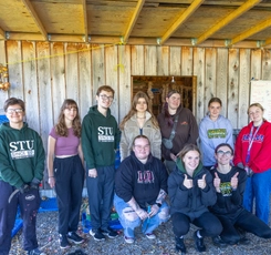 Group photo of STUdent volunteers at shed in NB community gardens