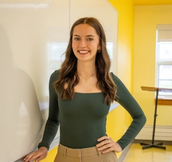 Virginia in classroom next to white board