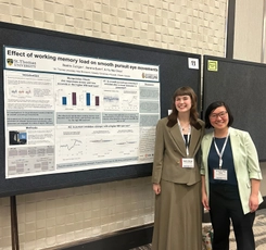 Beatrix and Dr. Chow smiling and standing next to their poster presentation at conference