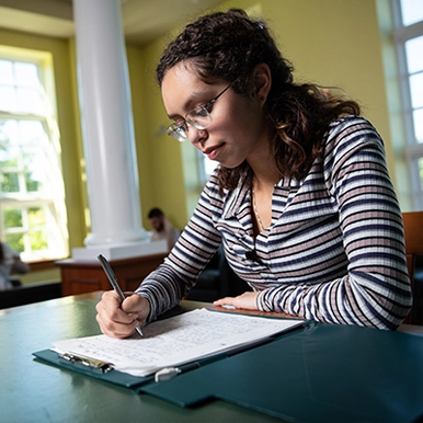 Student taking notes in study hall