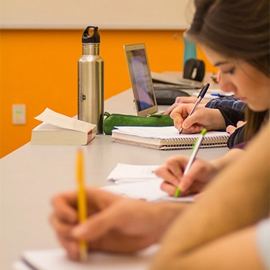 Students writing notes in class