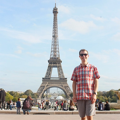 Student standing in front of Eiffel tower