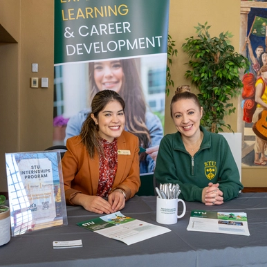 two staff members manning a booth about internships