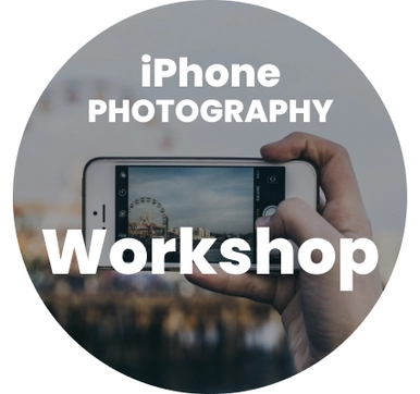 Hands holding a smartphone taking a photo with the words 