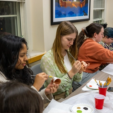 students painting plant pots