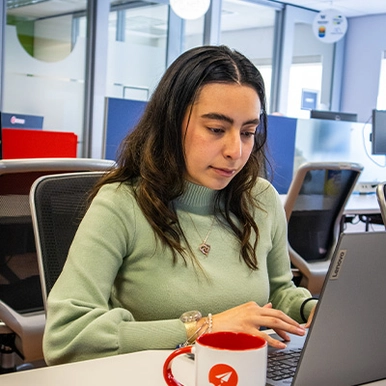 Student working on laptop at internship site