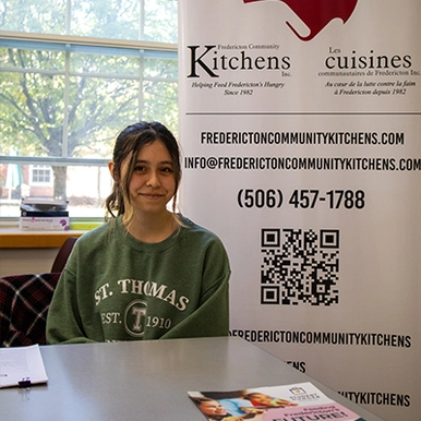 Student at booth at volunteer fair