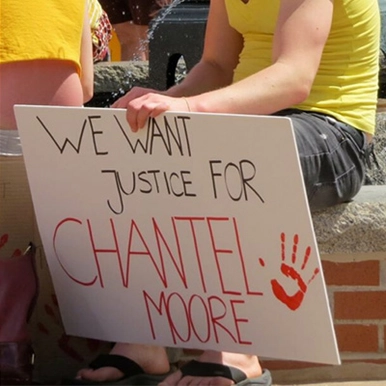 Someone holding a sign that reads 