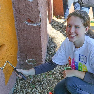 A student painting a school