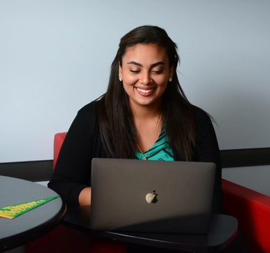 Photo of a student intern looking at her computer
