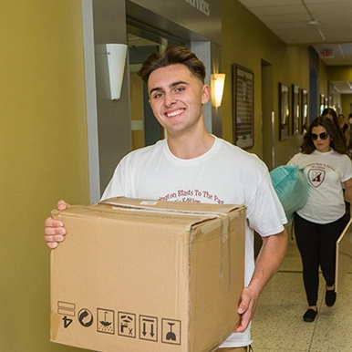 A student carrying a box