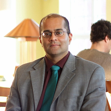 a photo of shaun narine sitting in the study hall at st. thomas university