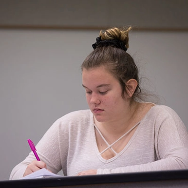 student taking notes in class