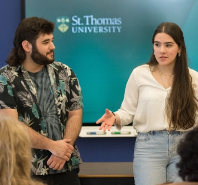 a photo of two students presenting in class