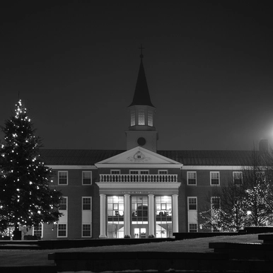 Photo of Campus in winter with Christmas lights in trees