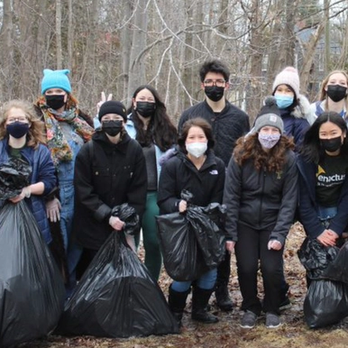 Students holding garbage bags