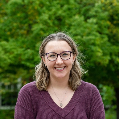 Mental Health Counsellor Brittany Sprague standing in front of some trees on campus