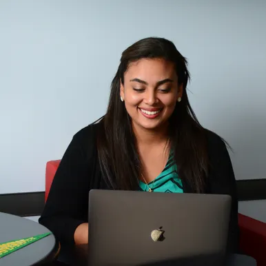A student-intern working on laptop