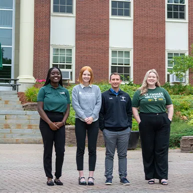Four admission counsellors standing group headshot