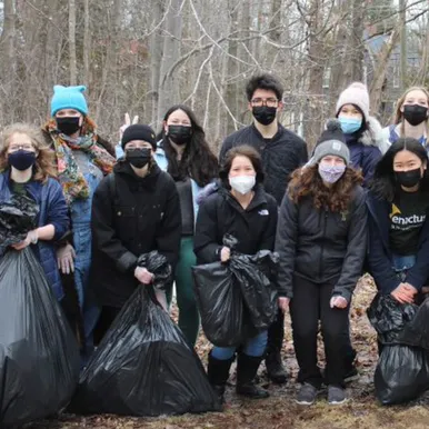 Students holding garbage bags