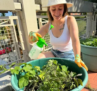 student watering plant