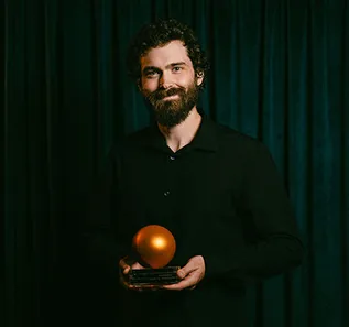 Zachary Greer holding Canadian Screen Music Award