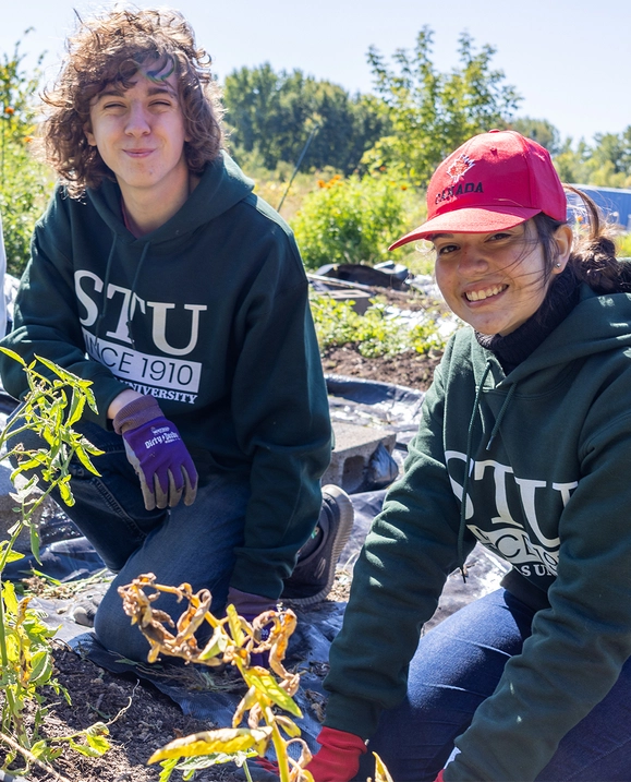 Students working in a garden for STU Cares event