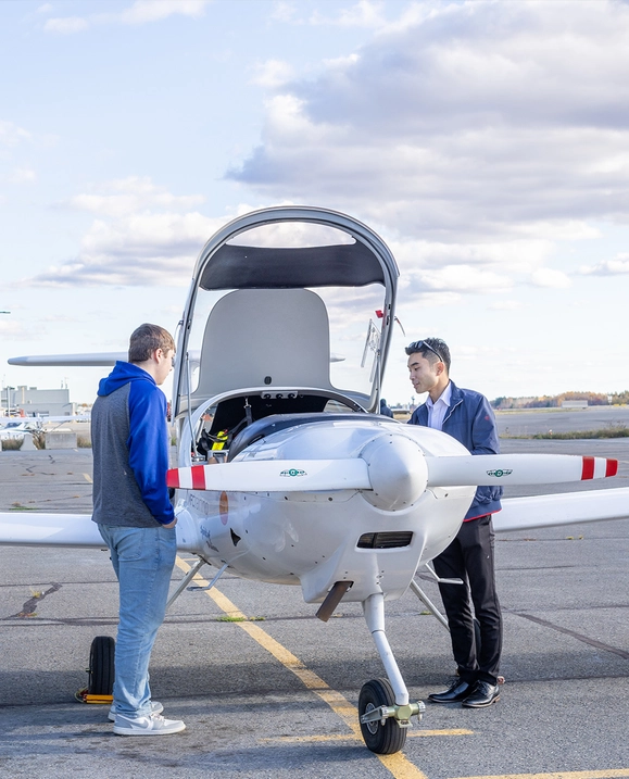 A student and MFC representative look inside the plane together