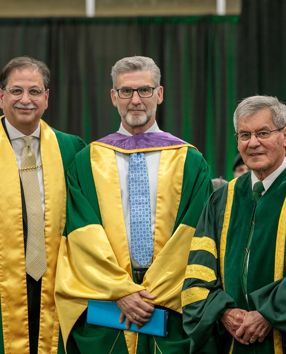 President Farooqi and the Hon. Graydon Nicholas present Harry Forestell with an Honorary Degree at Spring Convocation