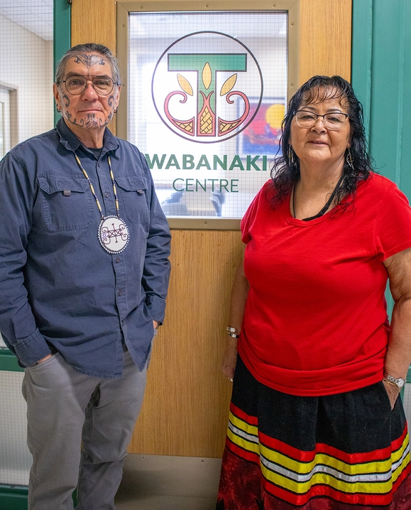 Ron Tremblay and Liz Augustine, STU's Elders in Residence, stand in front of the door to the Wabanaki Centre