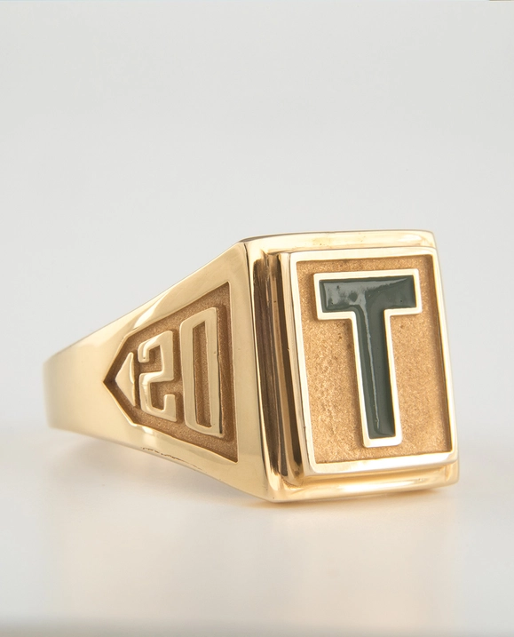 A  close up of a gold T-ring