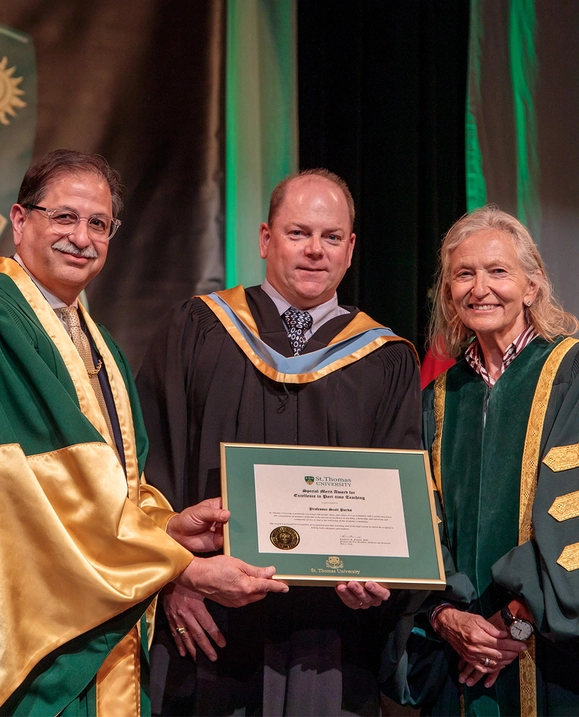 Dr. Farooqi and Chancellor Sandra Irving present Professor Scott Parks with the Excellence in Part-Time Teaching Award at Summer Convocation