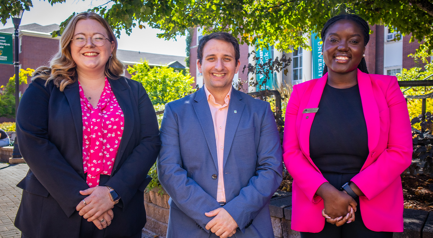 Admission Counsellors standing next to GMH: Hannah, Alex and Muchaneta