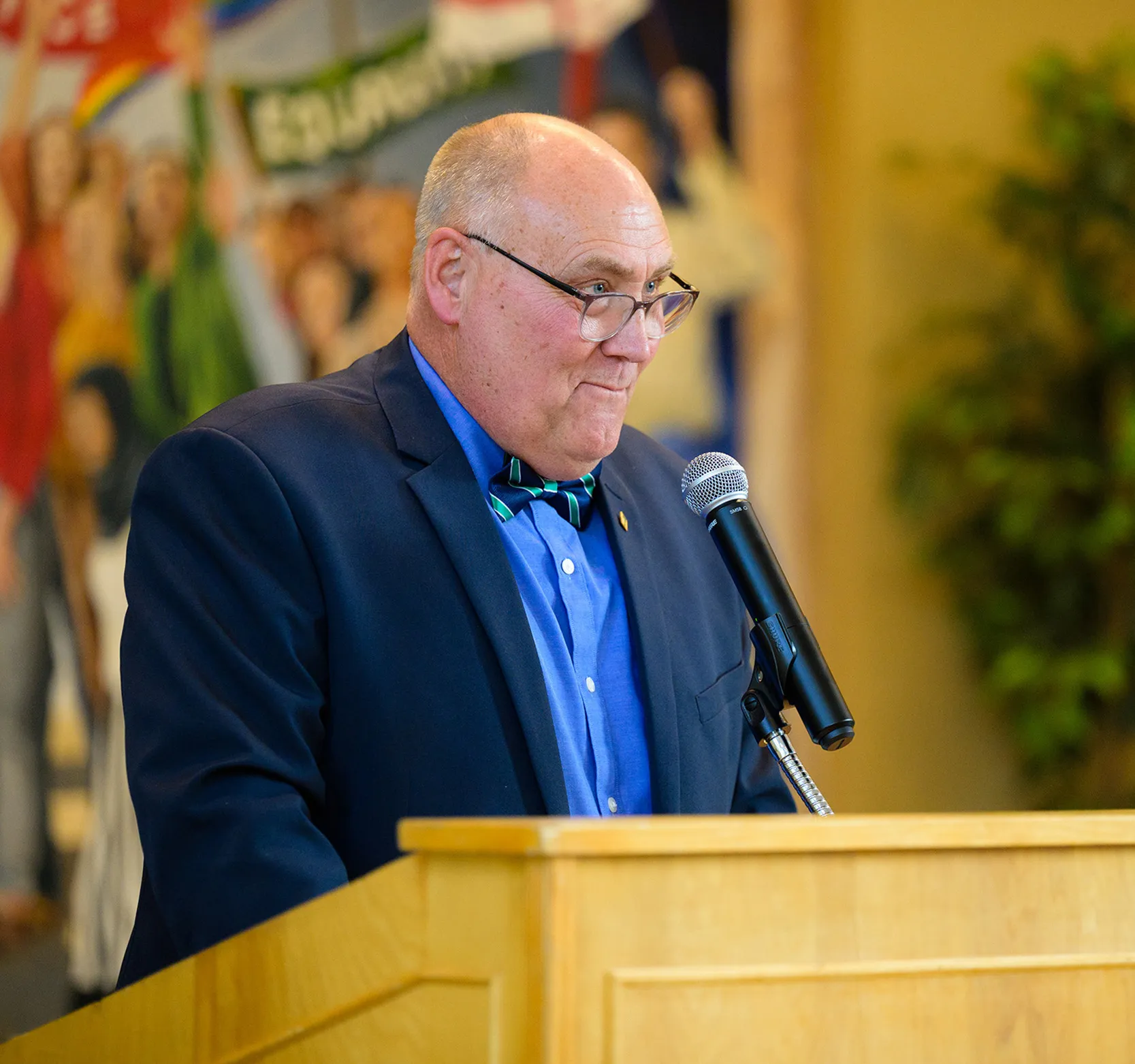 Dr. Grant Williams stands behind a podium in STU's Great Hall