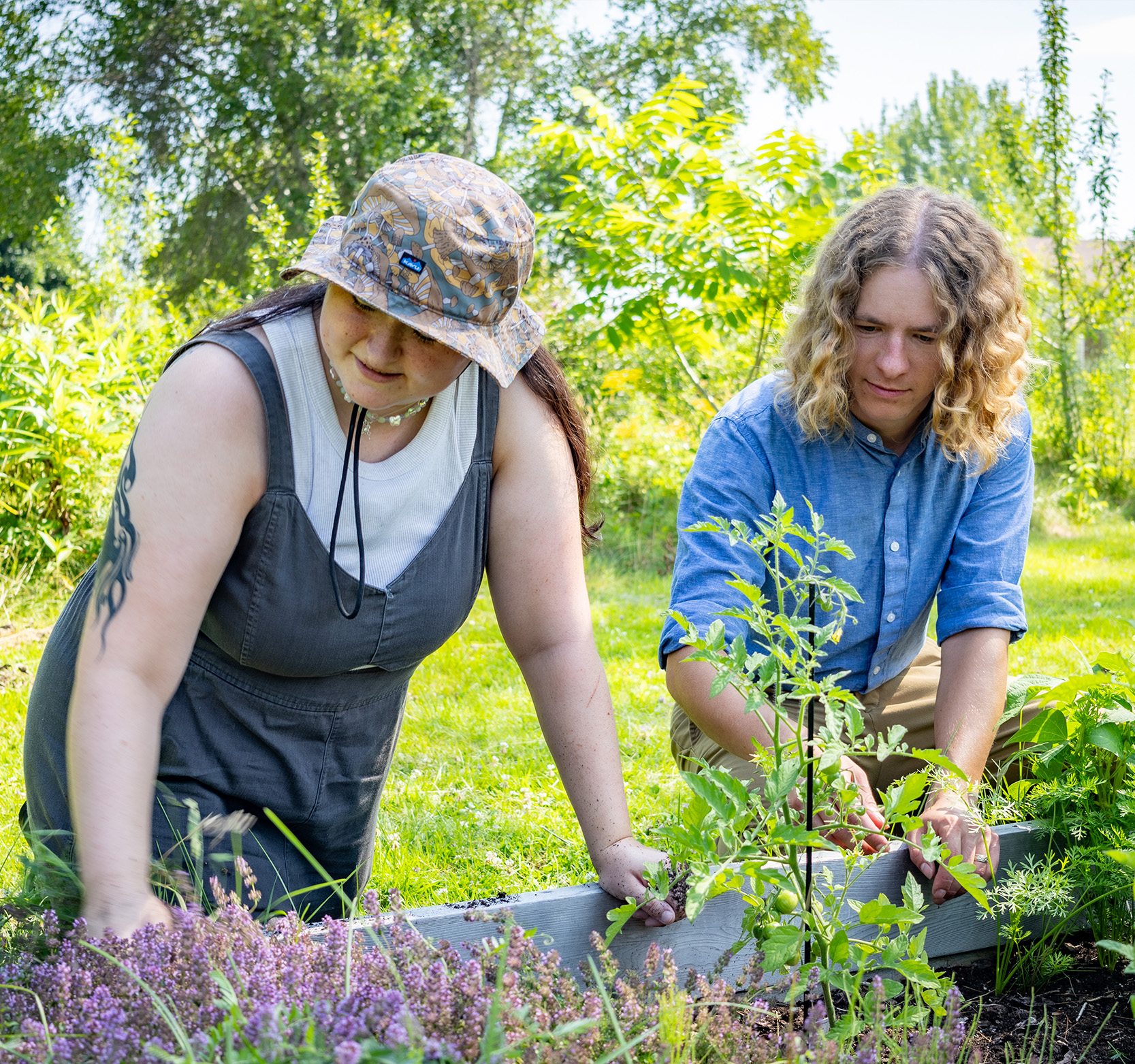 A female student and a male professor work together in a garden.