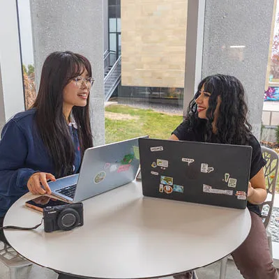 Two students sitting in a workplace