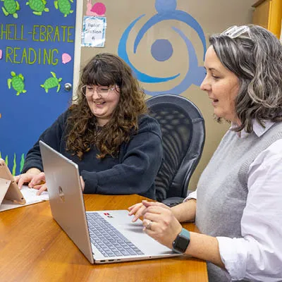 student and employer sitting at computers