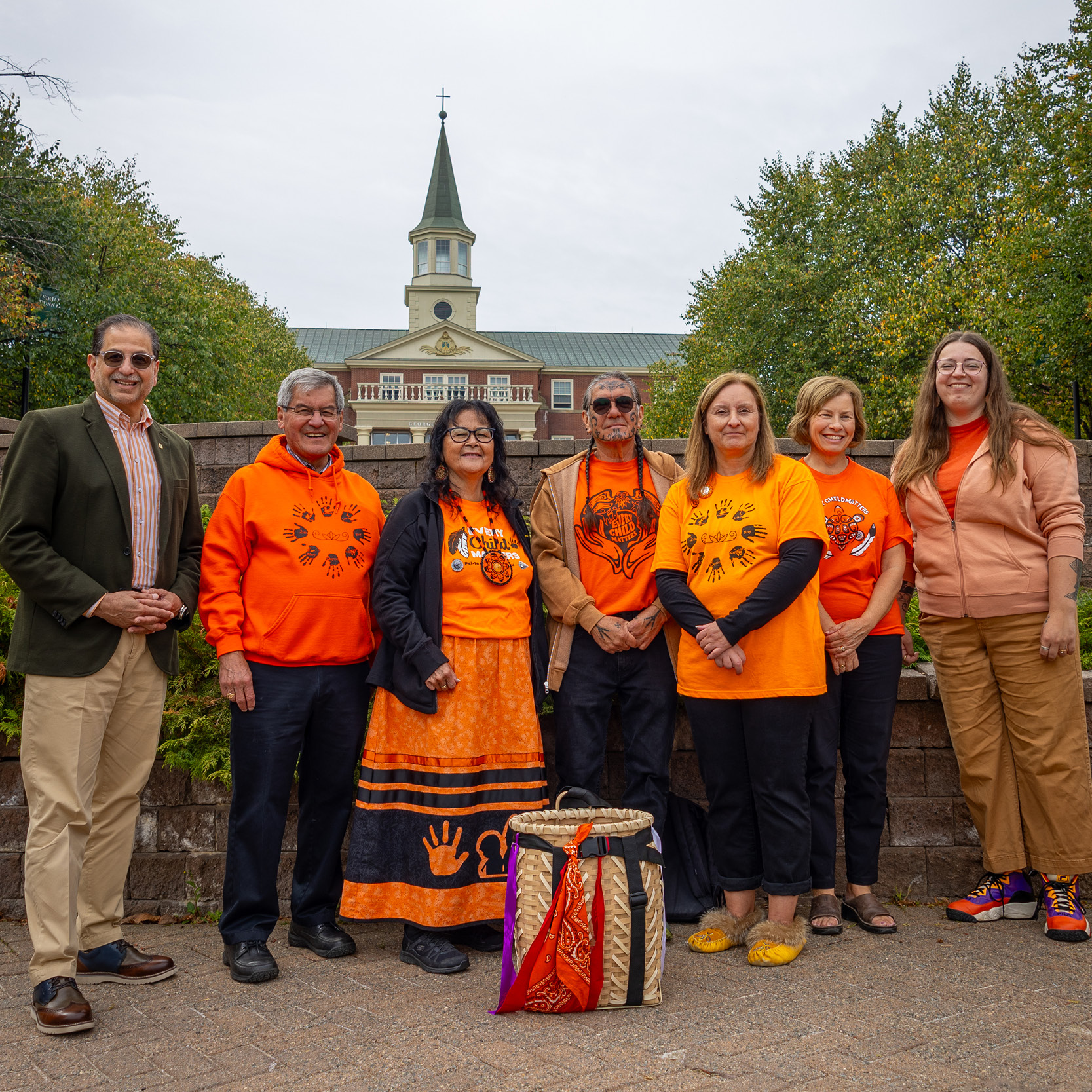 a group of people in the ������Ƶ Courtyard wearing orange shirts