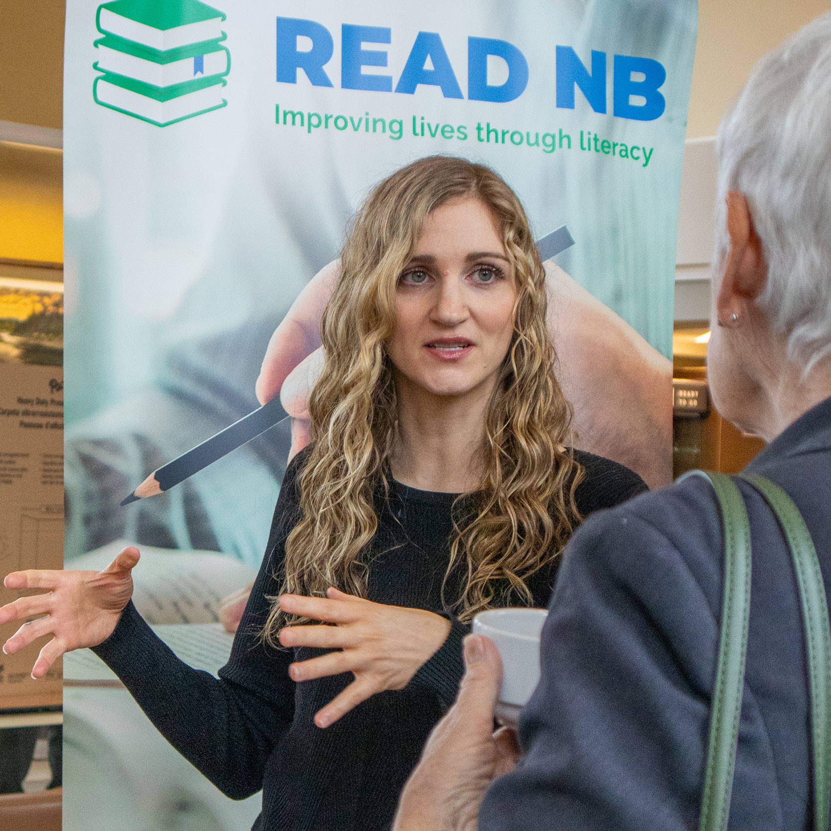 Student presenting her social action placement at a fair