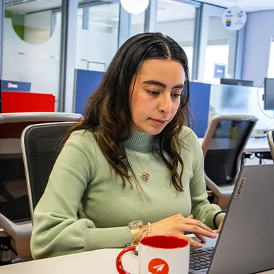Student working on laptop at internship site