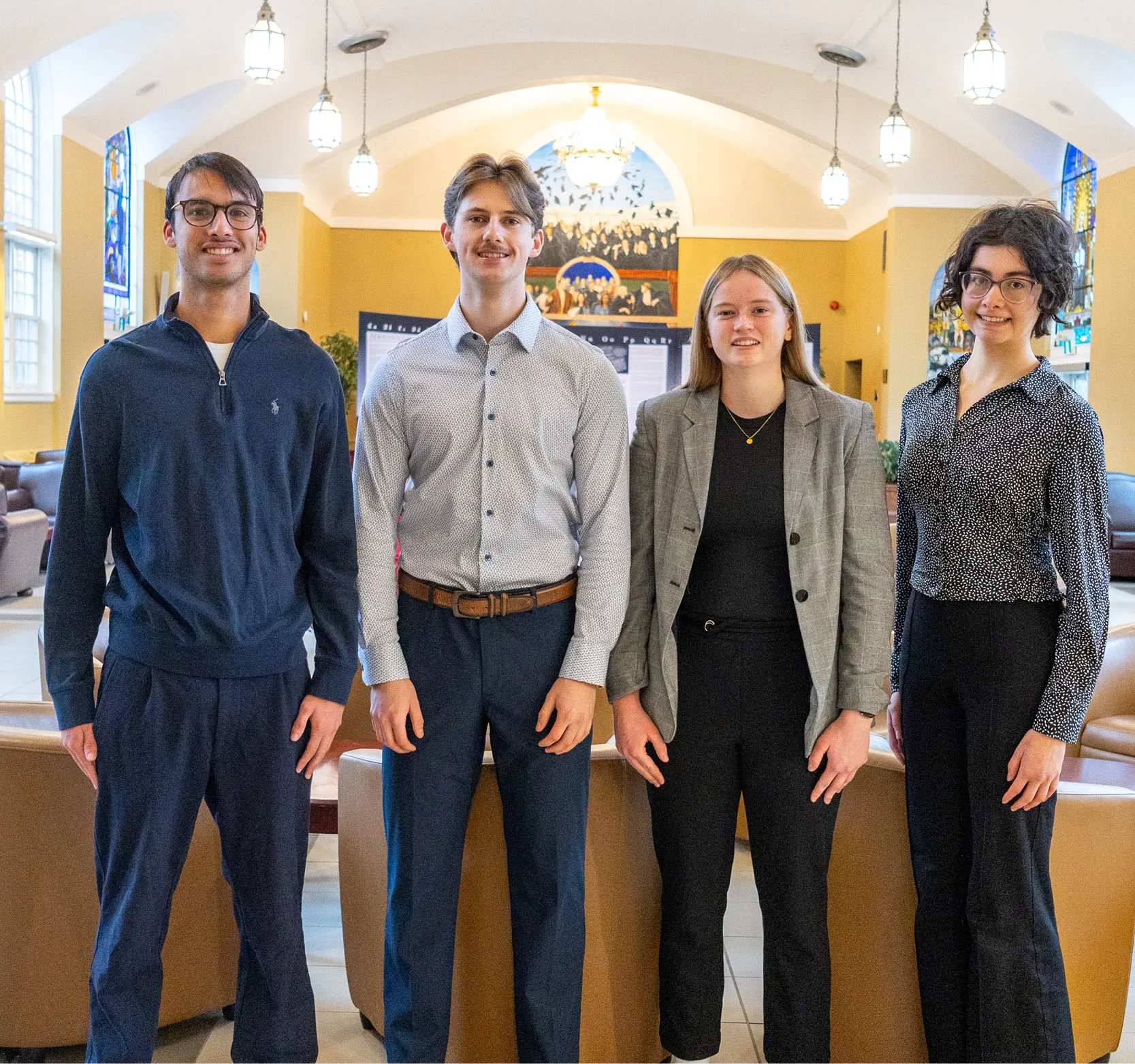 Group of Economics students standing and smiling in the Great Hall