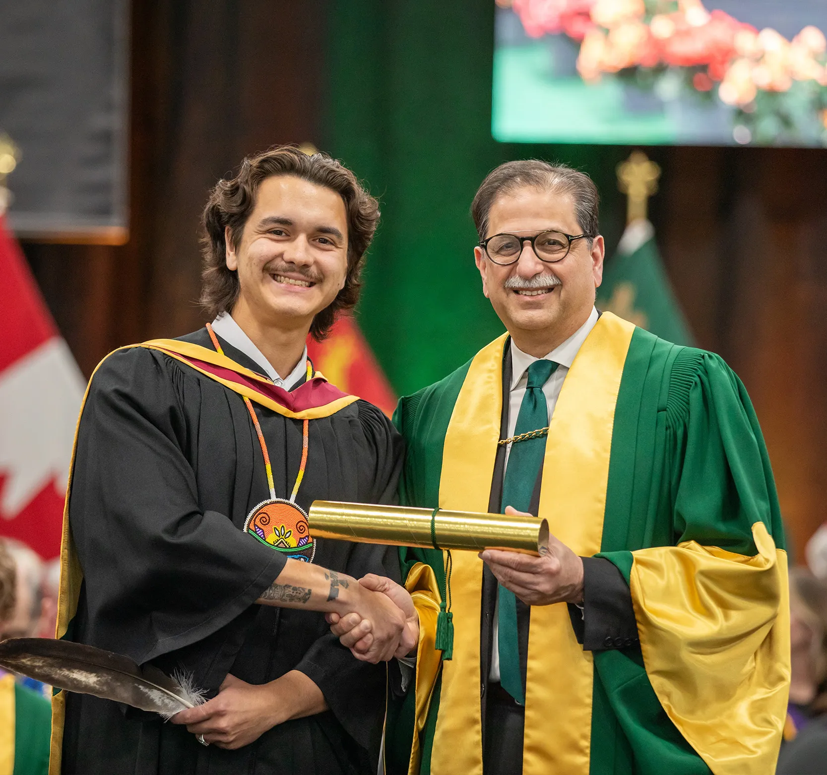 Student receiving his diploma from the president