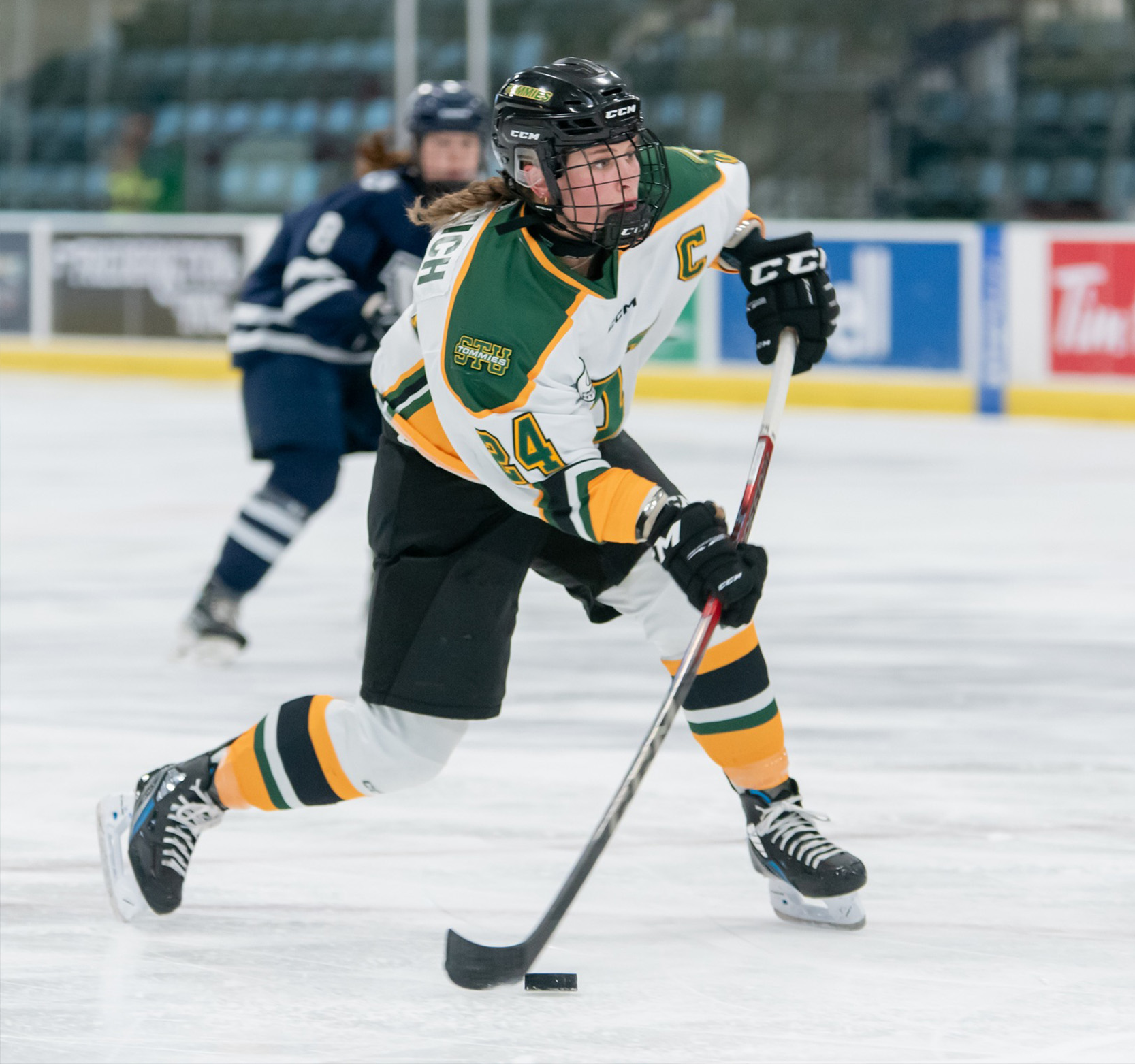 STU Women's Hockey captain Ekaterina Pelowich shooting the puck during game play