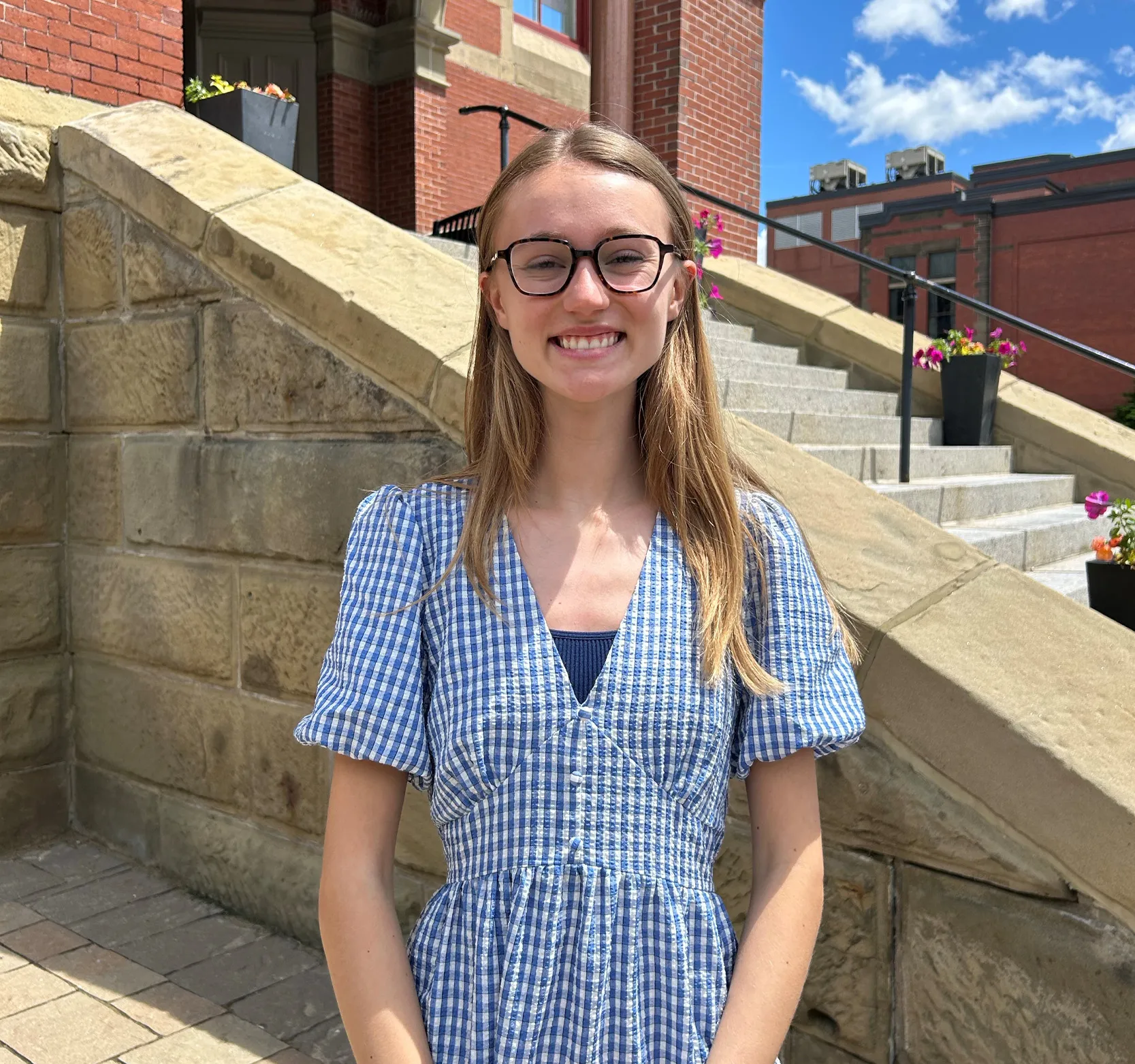 Emily Nylen standing in front of Fredericton City Hall building